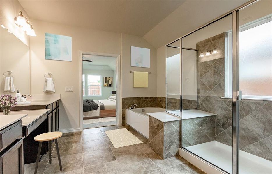 Owner's bath with double vanity and large shower *Photos of furnished model. Not actual home. Representative of floor plan. Some options and features may vary.