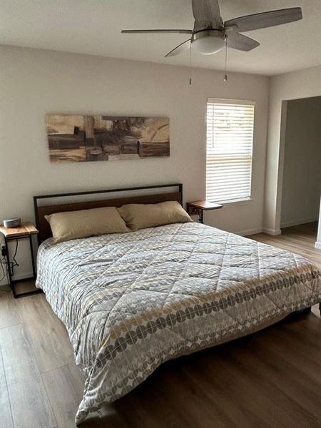 Bedroom with ceiling fan and light hardwood / wood-style flooring