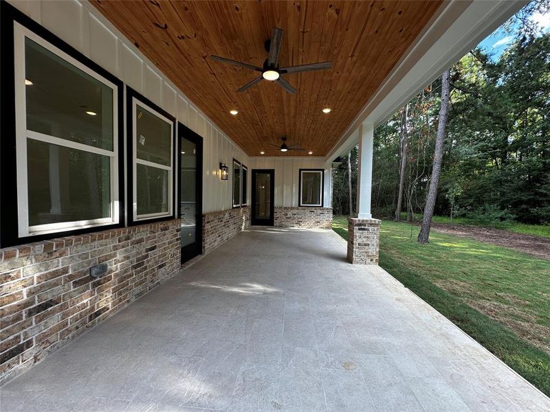 Back porch with tongue & groove accent ceiling and double fans