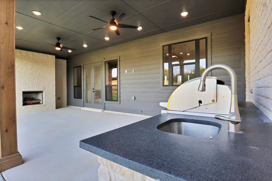 View of patio / terrace featuring ceiling fan, sink, and french doors