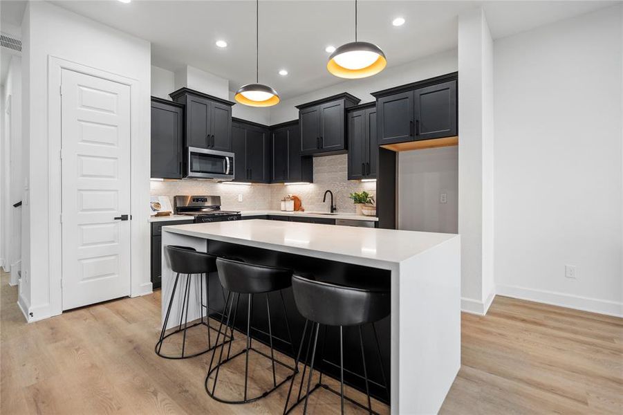 An oversized 7-foot quartz waterfall island commands attention in this culinary haven, complemented by a beautifully designed backsplash that adds glamour to every meal preparation. A perfect blend of style and functionality for the heart of your home.