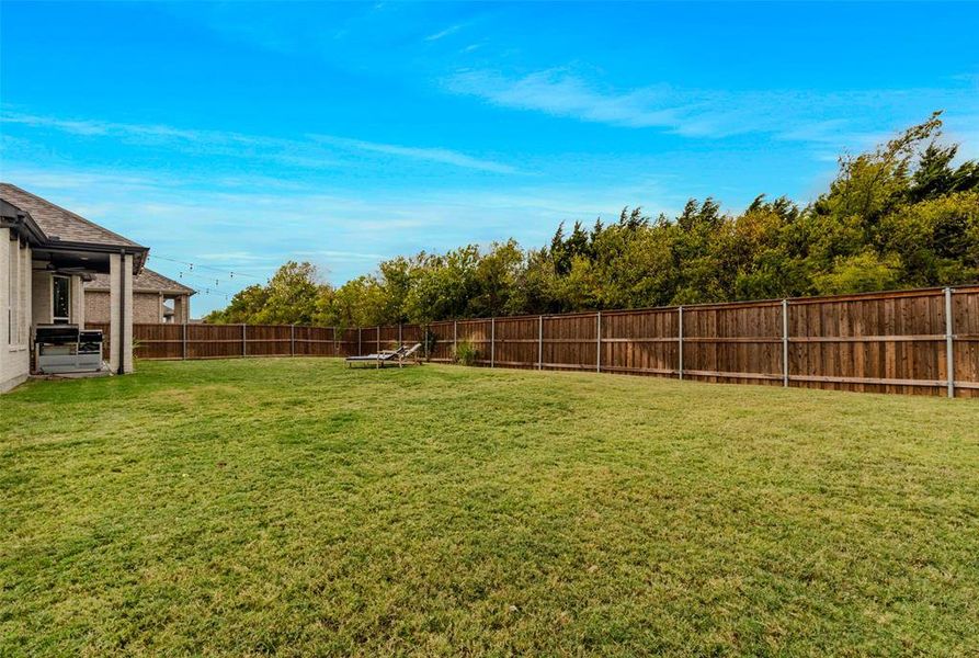 Backyard view of true greenbelt and mature trees behind the home