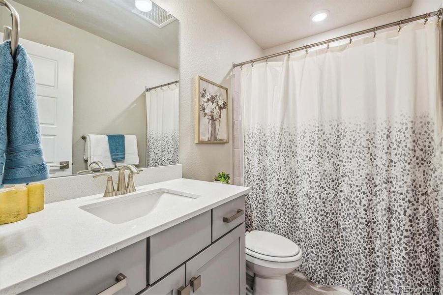 Main bath with tile surround  and upgraded fixtures & cabinetry