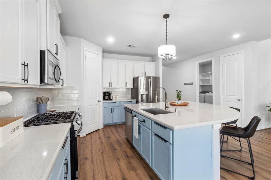 This kitchen has ample storage space with solid wood cabinets, soft close technology and upgraded hardware.  Enjoy your gas range stove with built-in air fryer!