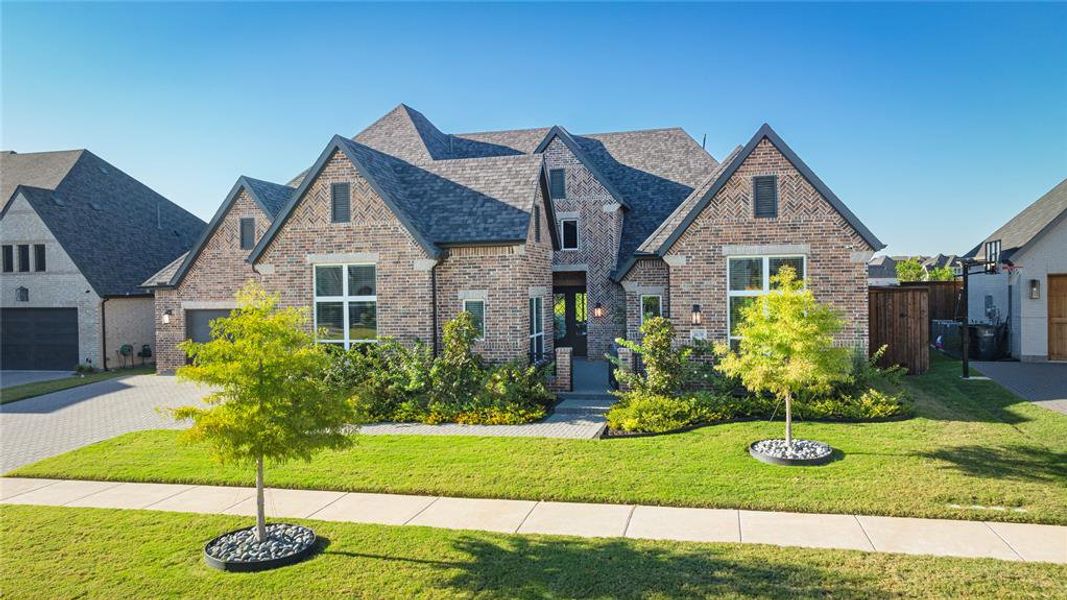 Tudor-style house featuring a front lawn