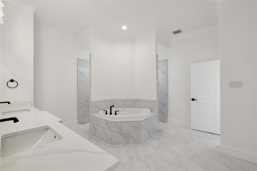 Bathroom featuring ornamental molding, vanity, and shower with separate bathtub