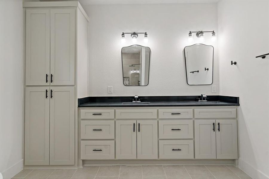 Bathroom with tile patterned floors and dual bowl vanity
