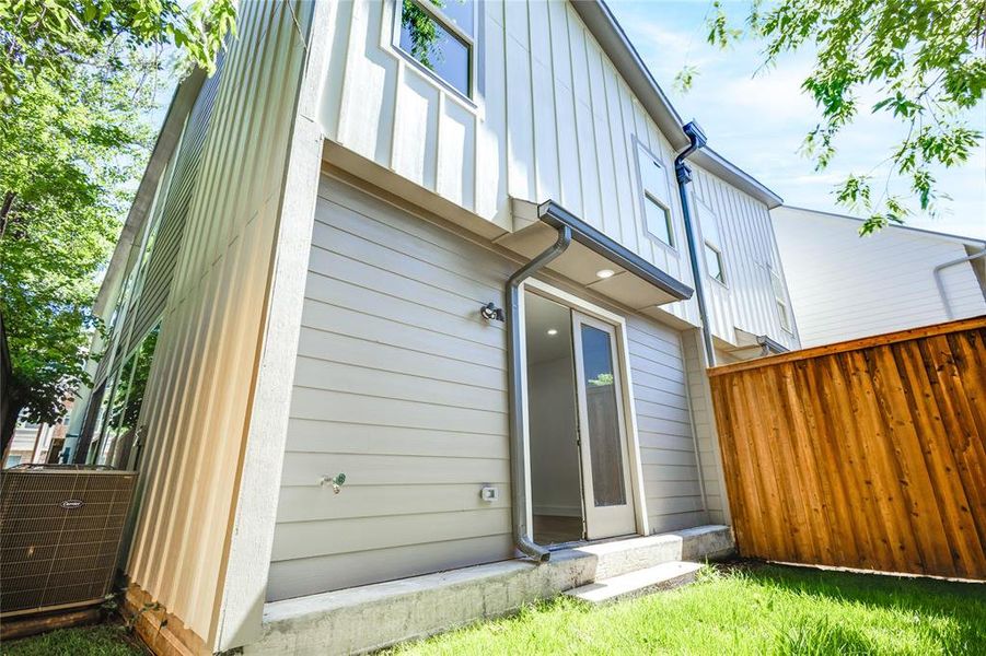 Rear view of property with central air condition unit