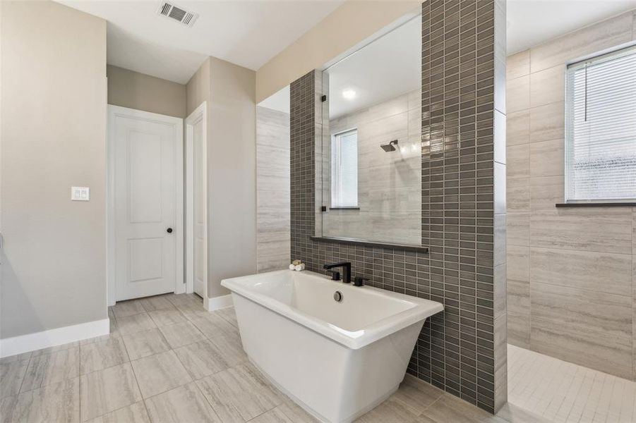 Bathroom with independent shower and bath and tile walls