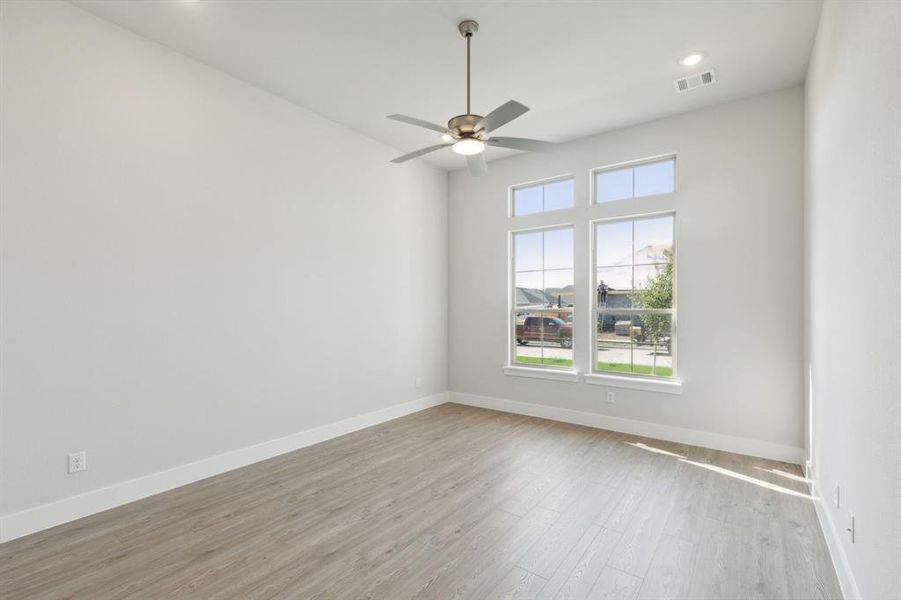 Unfurnished room featuring ceiling fan and light hardwood / wood-style floors