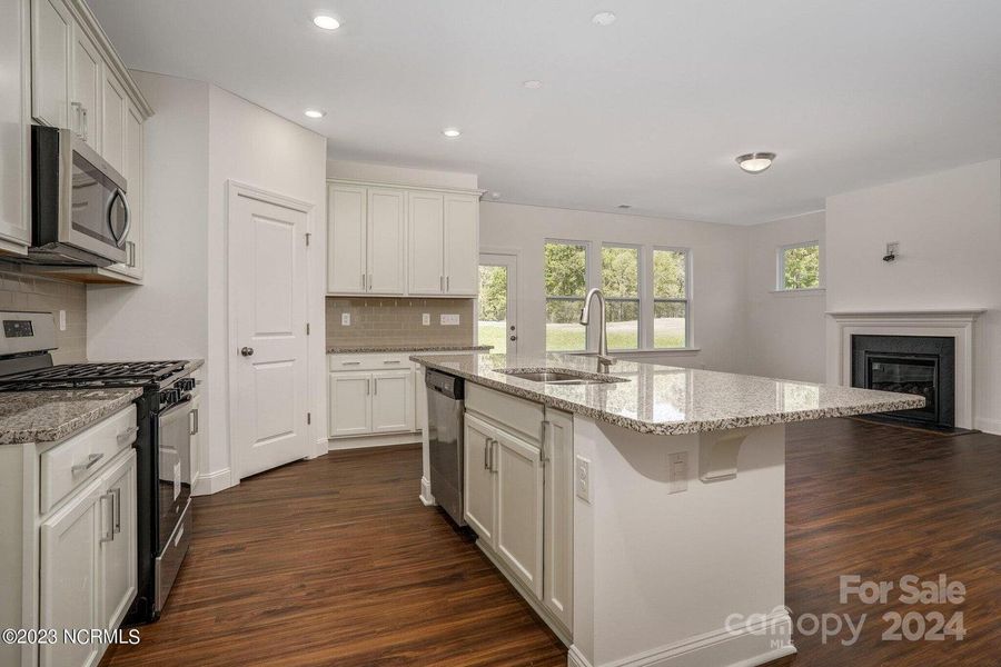 Concept photo of Upgraded Kitchen with granite counters, stainless steel appliances, large center island with seating, pantry, recessed lights & plenty of cabinets for storage!