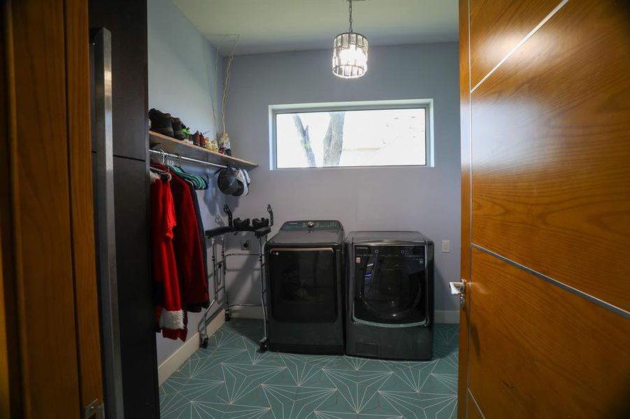Laundry area featuring tile floors and washer and clothes dryer