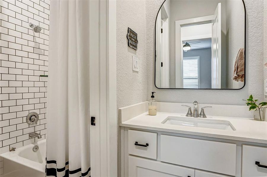 Guests will enjoy getting refreshed in the full tub shower combo with beautiful subway tile and Schluter trim from floor to ceiling.