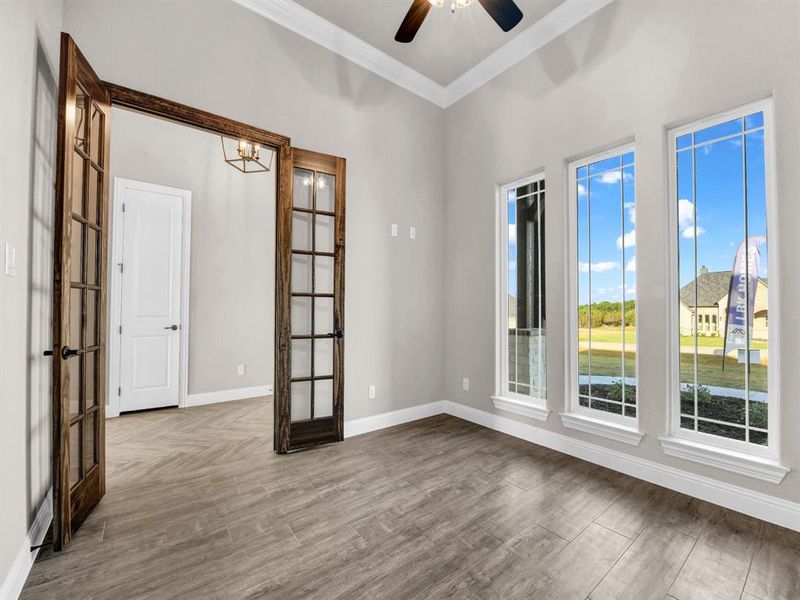 Unfurnished room with french doors, ornamental molding, ceiling fan, and hardwood / wood-style floors