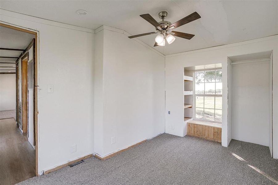 Unfurnished bedroom with ceiling fan, crown molding, and wood-type flooring