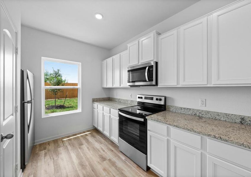 The kitchen features long granite countertops