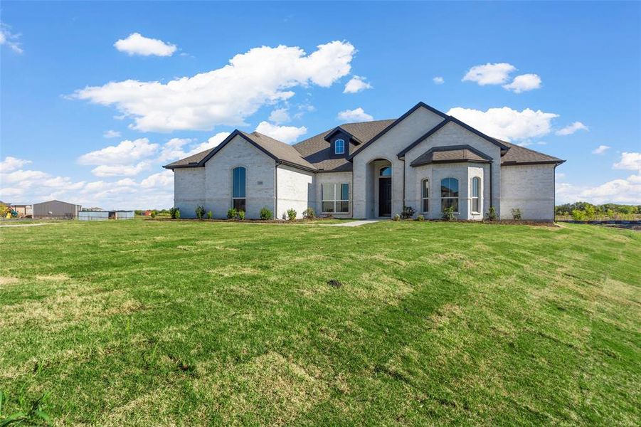 French country style house featuring a front yard