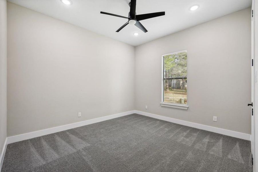 Spare room featuring carpet floors and ceiling fan