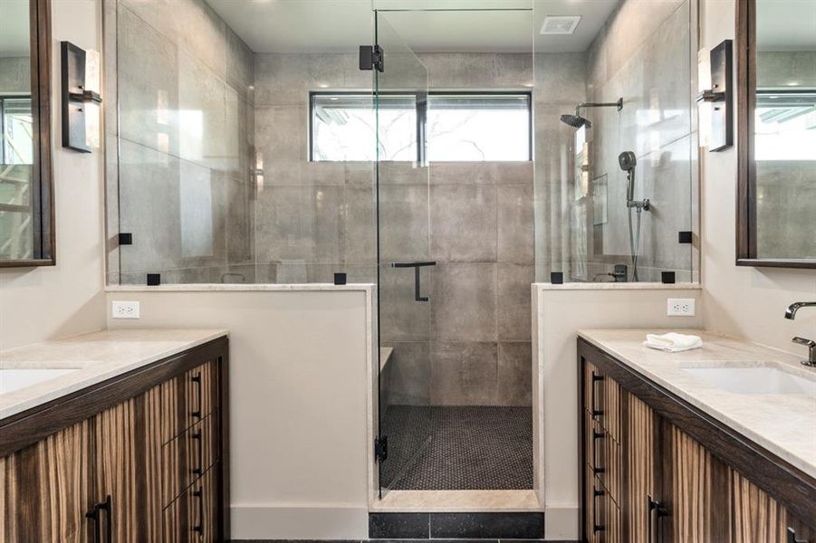 Bathroom with a shower with door and vanity