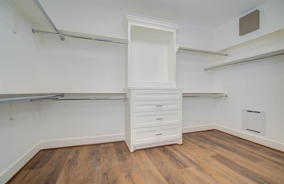 Perfectly designed walk-in closet with custom built drawers