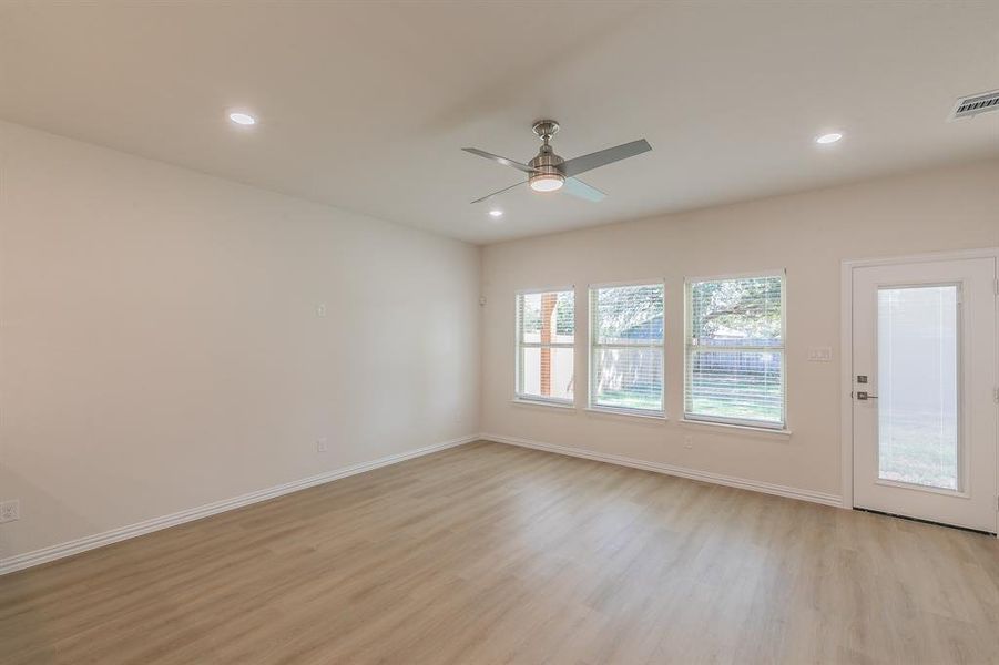 Spare room featuring ceiling fan and light hardwood / wood-style flooring