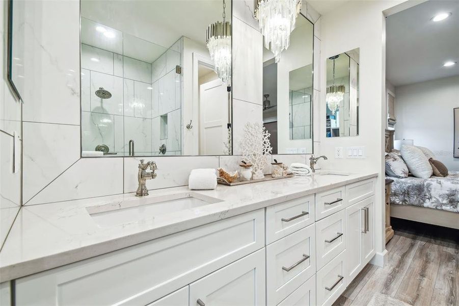 Primary bathroom. Dual sinks and built in-wall medicine cabinets.