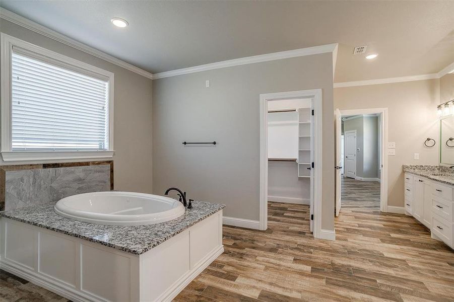 Spacious primary bathroom with 2 walk-in closets