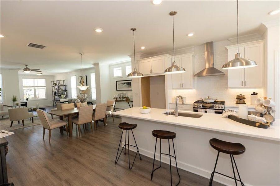 Kitchen opens to the dining area. *Photos of model home from a different community. Used for illustrative purposes only.*