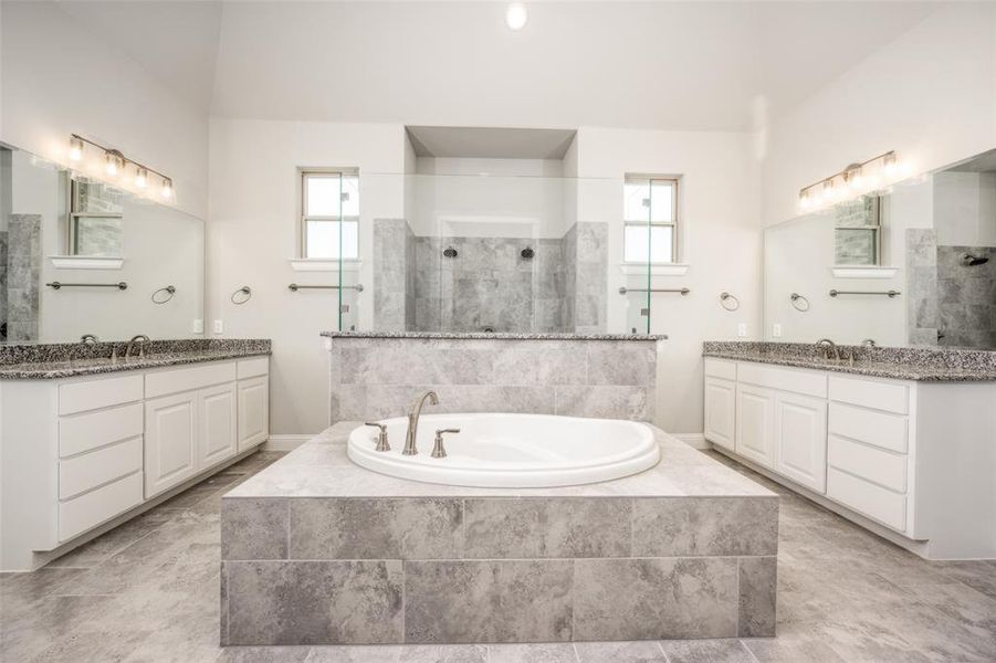 Bathroom featuring tile patterned flooring, dual bowl vanity, and a healthy amount of sunlight