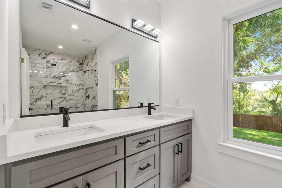 Bathroom featuring vanity and an enclosed shower