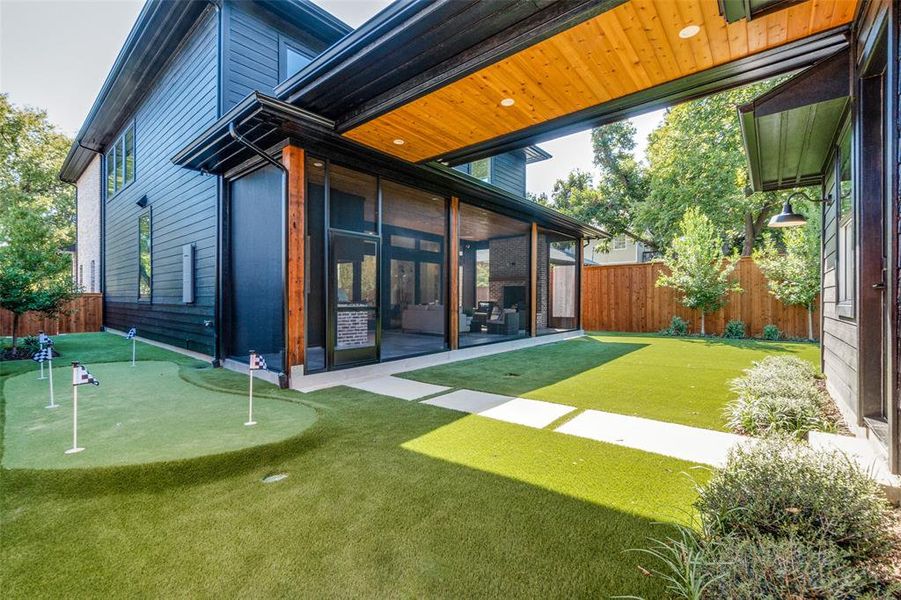 covered breezeway connects garage to home. fully turfed backyard with putting green.