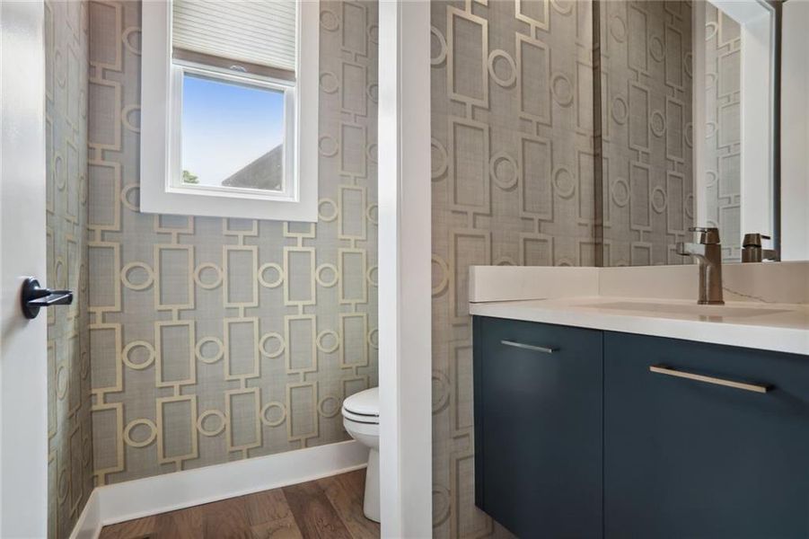 Powder room with designer wall coverings.