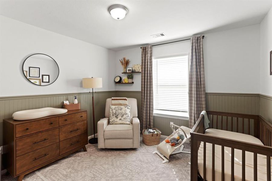 Charming nursery featuring elegant chair rail molding and tasteful decor, ready to welcome your little one.