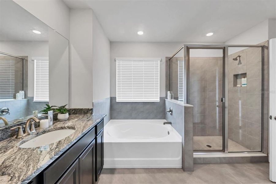 Master bath has granite with undermount sinks, garden tube and beautiful shower!