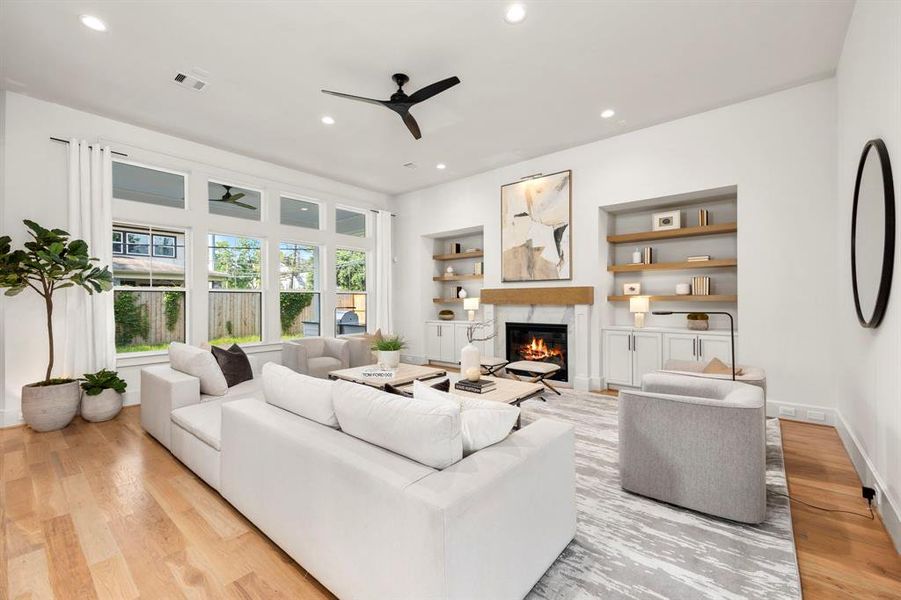 Family Room can accommodate large furniture formats & features custom built-ins, floating shelves & many large windows looking out to the back yard.