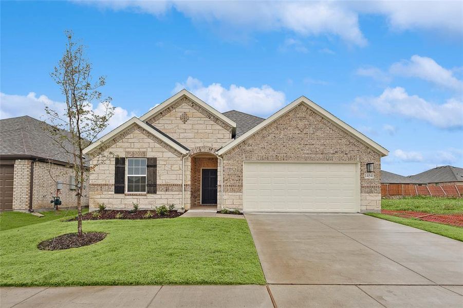 View of front of home featuring a garage and a front yard