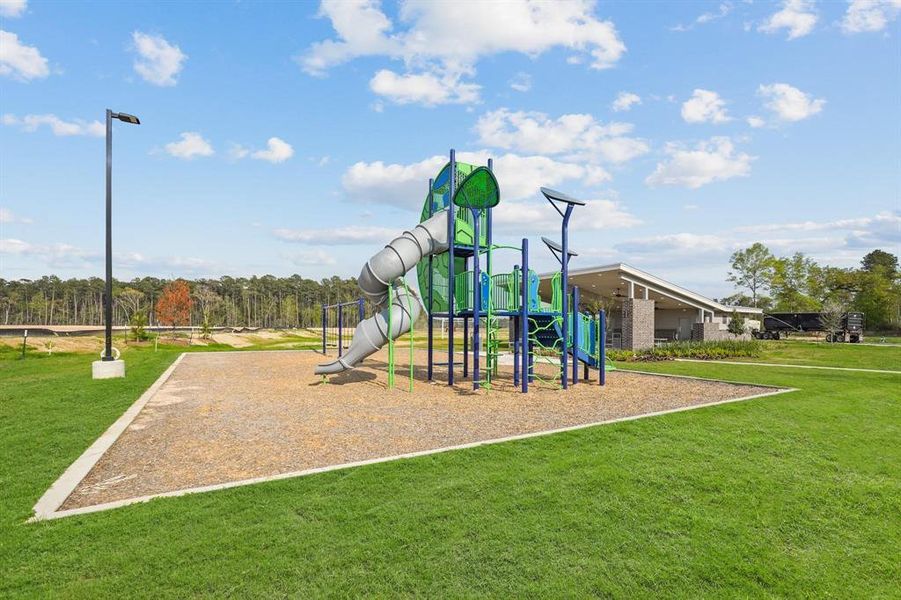 Another view of the playground, which includes a large slide and climbing structure, that provides an ideal play area for children!