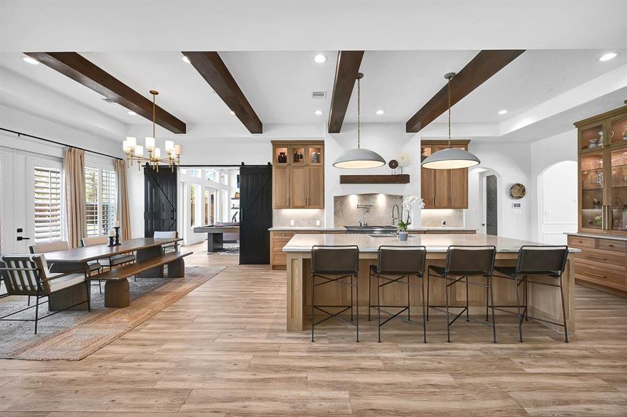 Elegant white oak kitchen featuring a spacious island and custom-built hutch, perfect for entertaining and storage.