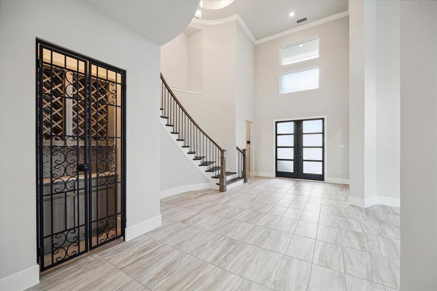 Another upgrade is this wine grotto with a beautiful wrought iron gate, bar, and stemware rack.