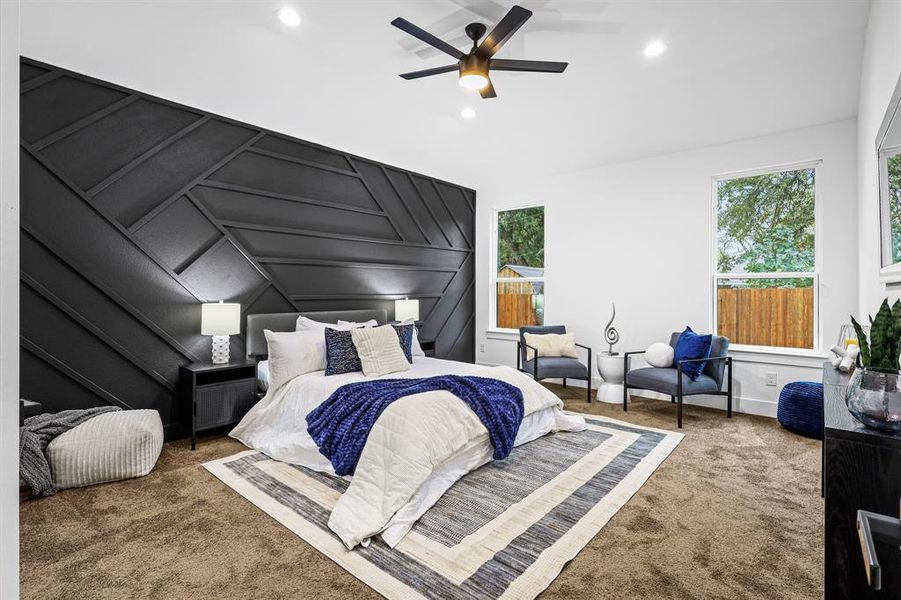 Carpeted bedroom featuring lofted ceiling and ceiling fan