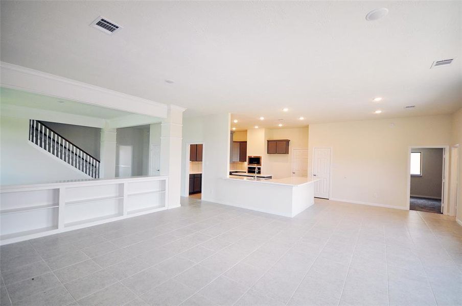 A quality crafted bookcase separates the Family Room from the Dining Room providing a convenient serving buffet for entertaining and family gatherings.