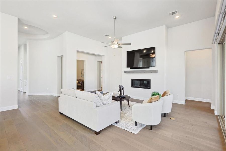 Living room featuring light hardwood / wood-style floors and ceiling fan