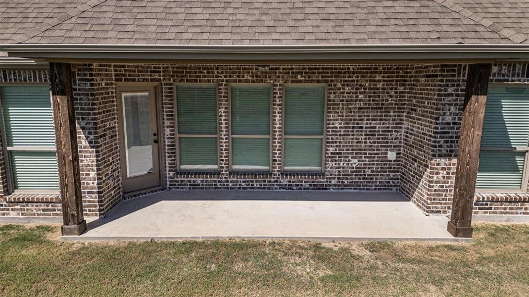 Doorway to property featuring a patio area