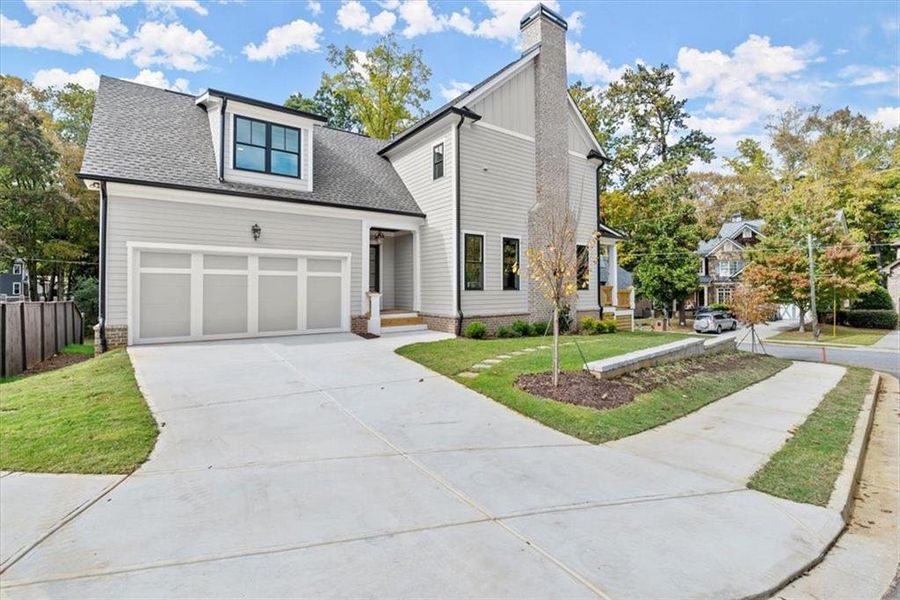 Front facade featuring a front lawn and a garage