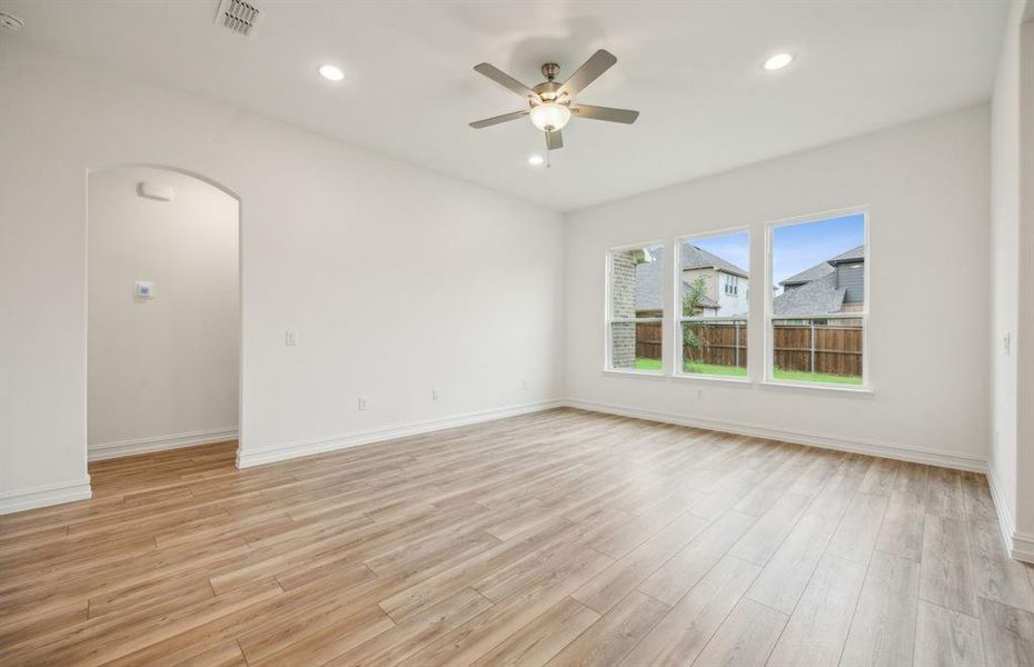 Spacious gathering room with large windows *real home pictured