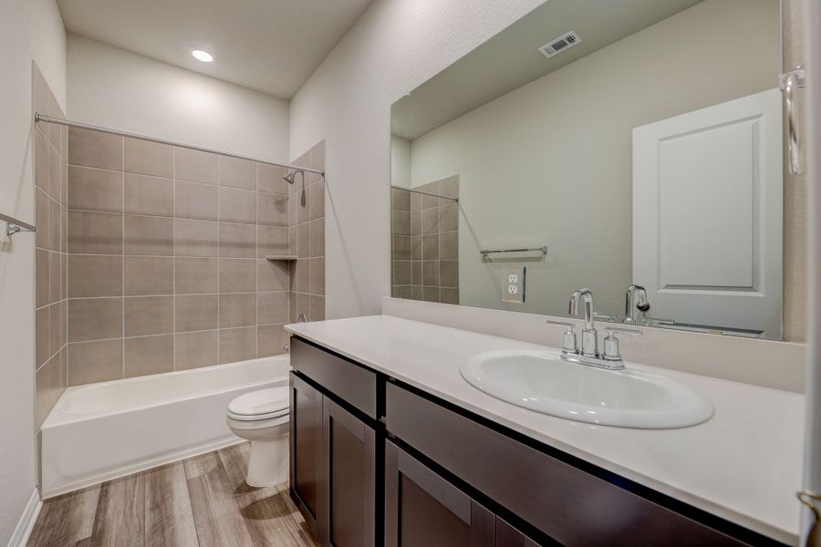 The secondary bathrooms in this home make getting ready easier for everyone.