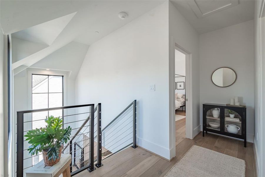 Corridor featuring light hardwood and Pella windows