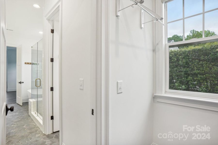 Laundry room located just adjacent to the primary bathroom and walk in closets.