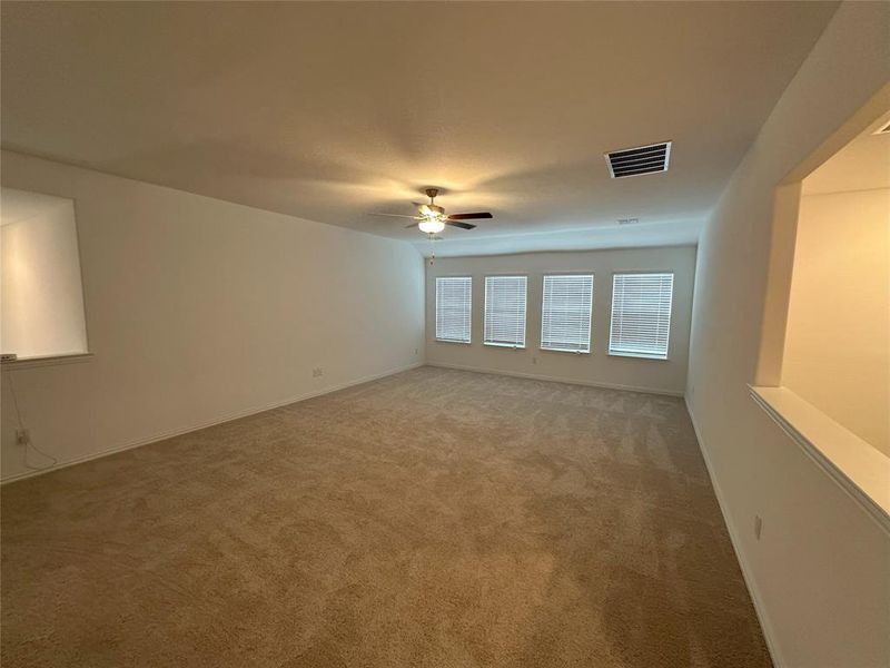 Spare room with carpet flooring and ceiling fan