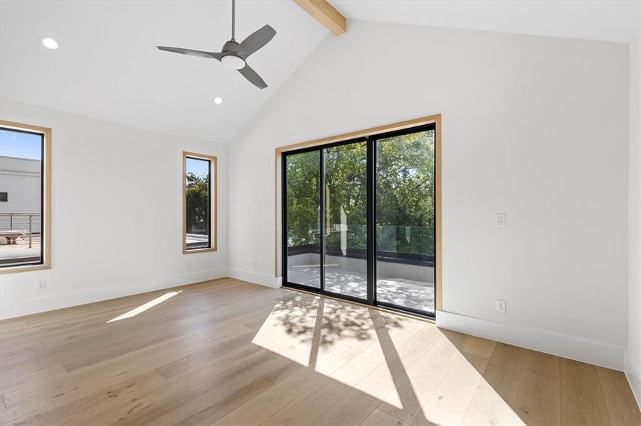 Spare room featuring light hardwood / wood-style flooring, beam ceiling, and a healthy amount of sunlight